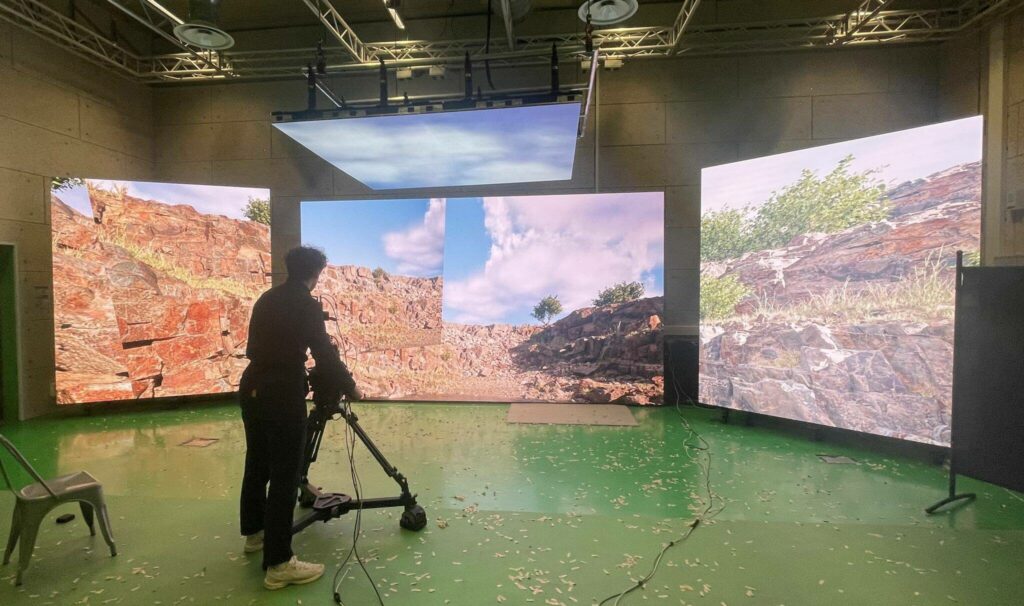 A virtual production stage in use, with the LED wall lighting the set